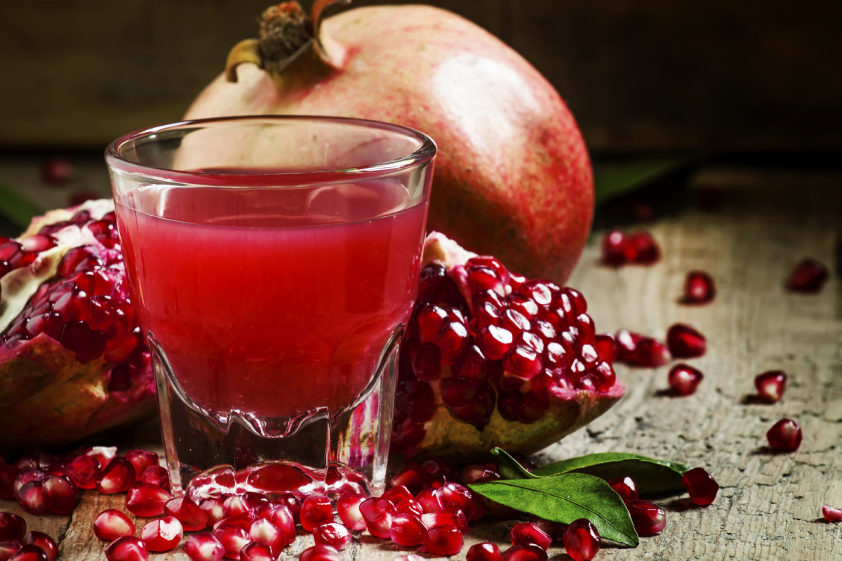 Freshly squeezed pomegranate juice, selective focus Red Crown Pomegranate Juice